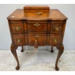 An English late 19th / early 20th century walnut lowboy in the Queen Anne style, with shaped top and