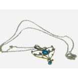 A 9ct yellow gold pendant set with blue faceted stones and seed pearls in a heart shaped design,