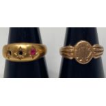 An 18ct gold ring, gypsy set with a ruby coloured stone (2 stones missing) gross weight