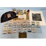 A mixed lot of military collectables including cap and shoulder badges, trench-art kukri knife