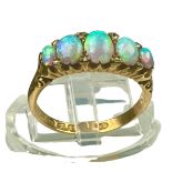 An 18ct yellow gold opal and diamond ring, set with five graduated opals, with small eight-cut