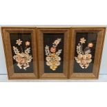A set of three shell work / sailors valentine style floral dioramas, sand encrusted mounts, glazed