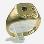 A 9ct yellow gold signet ring, with a star-set garnet to the top, ring weighs 6.3 grams, finger size