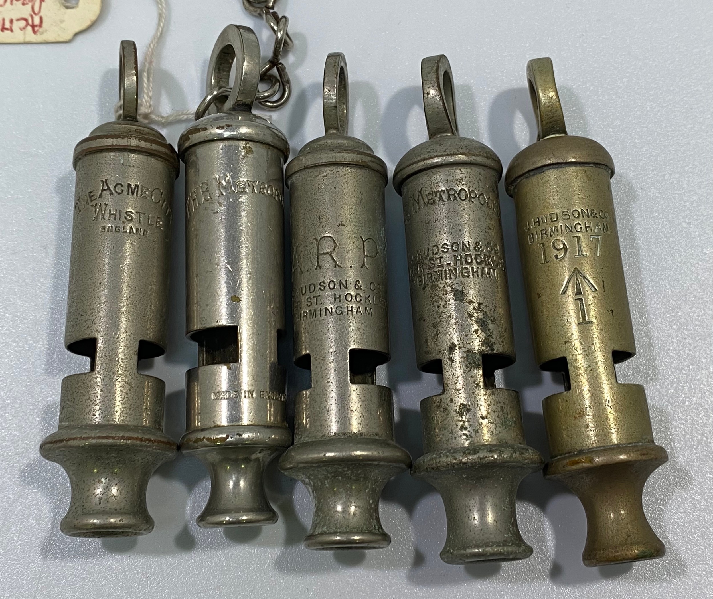 Five various whistles including a WW1 Huddson No.1 dated 1917 with broad arrow, ACME City, ARP and - Image 2 of 2
