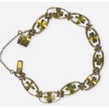 A 15ct yellow gold bracelet in an oval link design with gold four-leaf clovers set to the centre