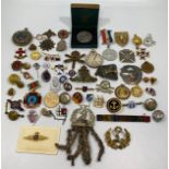 A quantity of badges including maritime / militaria themed items, cap badges of the Machine Gun