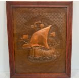An Arts and Crafts period copper panel with central embossed image of a ship at sea, possibly from a