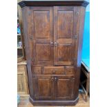 A good quality contemporary Georgian 'style' oak corner cupboard, the two panelled doors enclosing