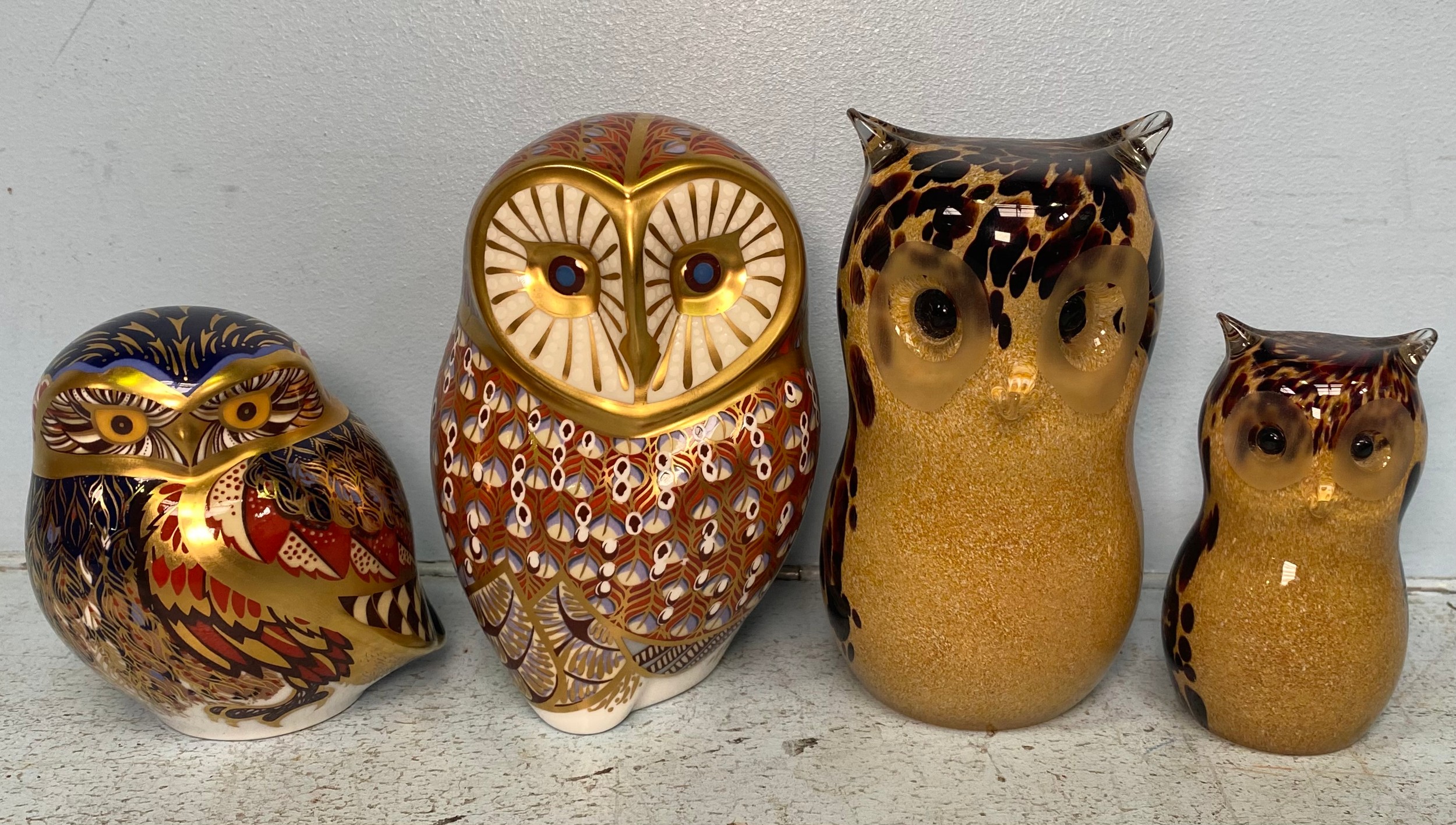 Four various paperweights modelled as owls, including two Royal Crown Derby examples, both with