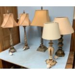 A pair of tall table lamps with silvered twisted and beaded bases and shaped shades, together with a