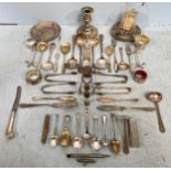 A small quantity of silver-plated flatware, two pin dishes, candlestick, thimbles, silver handled