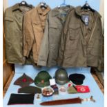 A quantity of replica military jackets, helmet, Russian cap, Vietnamese helmet, communist and German