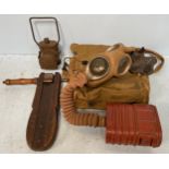 A WW2 Gas warning rattle, gas mask and canvas bag together with a WW2 Black-out cycle lamp, (3)