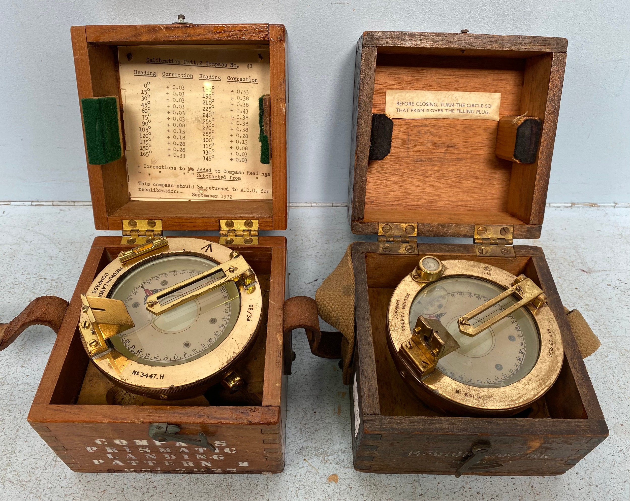 Two various brass Adnirlaty Pattern Medium Landing Compasses, in fitted wooden protectve storage