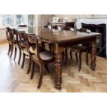 A Victorian walnut extending rectangular dining table the top with Ovolo moulded edge, three extra