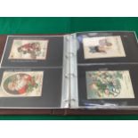 Four albums – two containing more than 210 Christmas themed postcards, with a number featuring