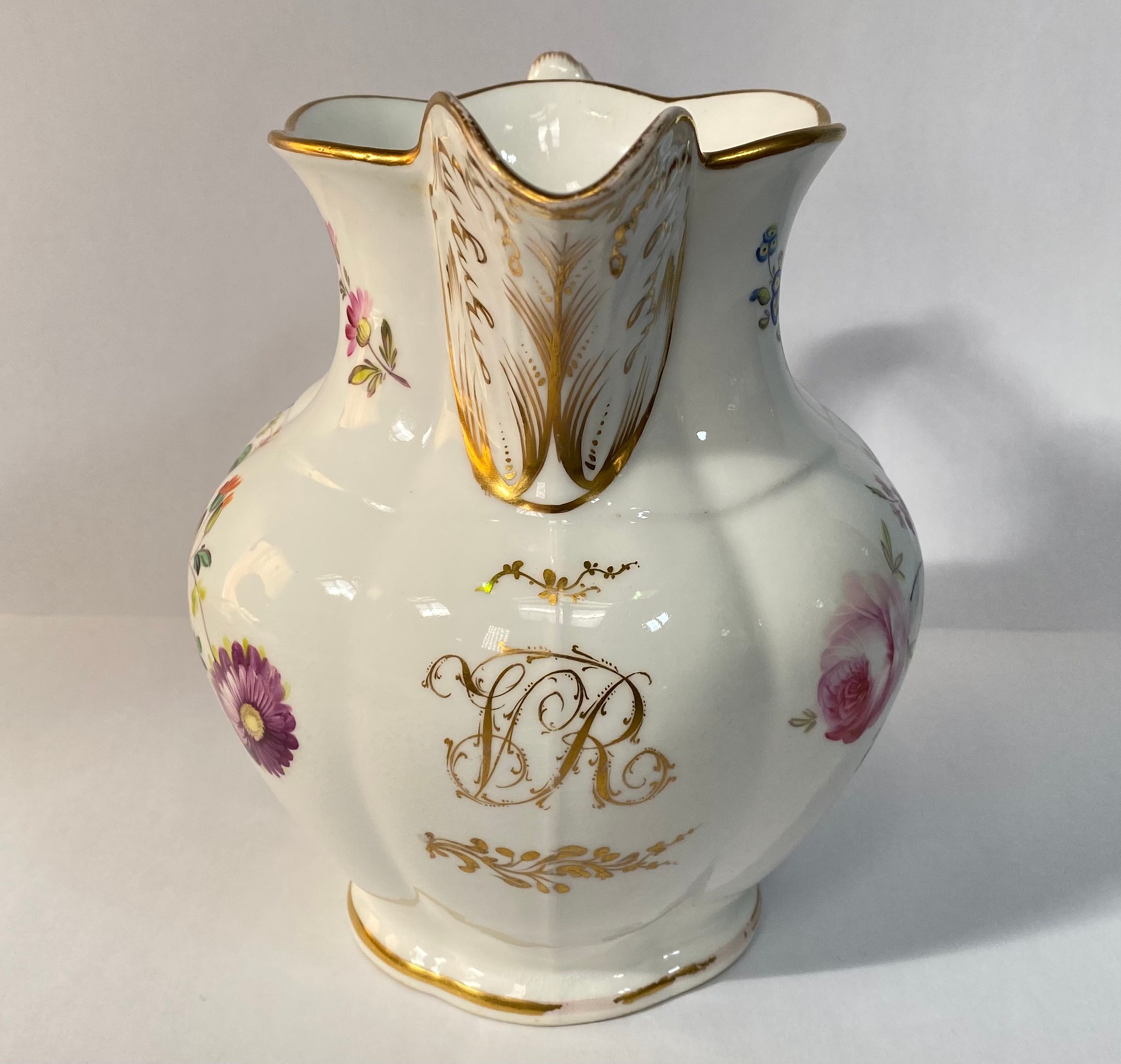 A 19th century porcelain jug, painted with flowers and with a gilt monogram 'VR', 19cm high, - Image 3 of 6
