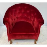 A red button-back velvet upholstered tub chair with rope twist edging, raised on squat cabriole