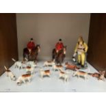 Two Beswick pottery mounted huntsmen wearing red jackets, together with eight Beswick hounds, a