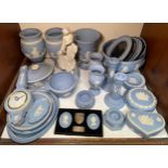 A large quantity of Wedgwood blue and white Jasperware including a barometer, vases, candlesticks,