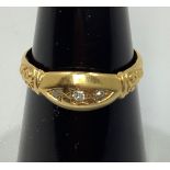 An 18ct gold ring gypsy set with three small diamonds, 2.9g, ring size N