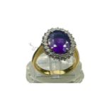 An 18ct yellow gold dress ring, set with a large oval amethyst to the centre, measuring