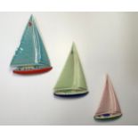 A set of three porcelain yachts by Wade of Ireland, in original box