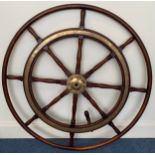 A large stained oak ships wheel with brass ring and hub mounts, reputedly from a Zanzibar sloop,