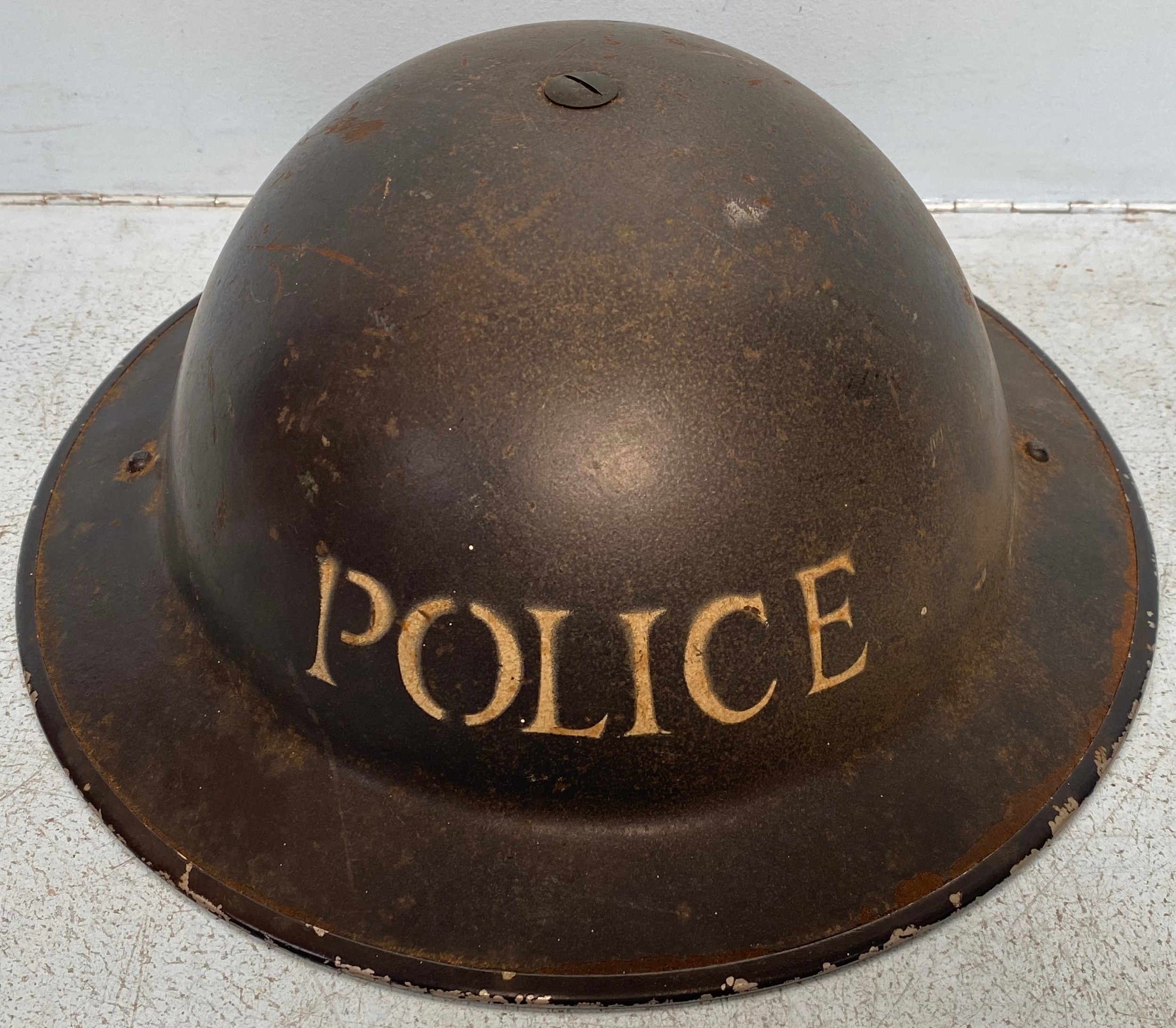 A WW2 Policeman's steel helmet with stencilled letters, with inner leather brace and straps