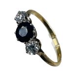 An 18ct gold sapphire and diamond ring, set with a round dark blue sapphire to the centre, with a