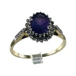 A 9ct yellow gold amethyst and diamond cluster ring, with an oval amethyst to the centre, surrounded