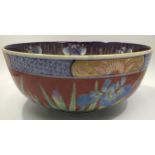 A large Oriental pottery bowl, decorated in polychrome enamels with floral designs, 31cm diameter