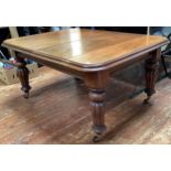 A very large rectangular extending mahogany dining table with stepped rounded edges and corners