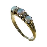 An 18ct yellow gold opal and diamond ring, claw set with three opals and four small diamonds,