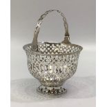 A silver sugar basket by Barker Brothers, the entirety with pierced decoration and hinged handle,