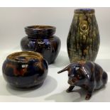 A Langley Pottery piggy bank, two tobacco jars and a vase, decorated with mottled ''tortoiseshell'