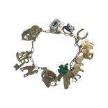 A 9ct yellow gold charm bracelet, with 17 x charms, including a four leaf clover, a key, a St