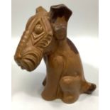 A Langley Pottery brown-glazed model of seated terrier dog, c1931-39, 22cm high Condition: Left