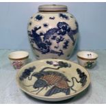 A large Chinese porcelain ginger jar and cover painted in underglaze cobalt blue with dragons amidst