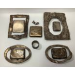 A small collection of assorted silver items comprising five various cigarette cases, a napkin ring