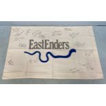 An Eastenders tea towel, signed by multiple cast members, past and present, including Barbara