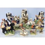 A collection of thirteen various 19th and 20th century Staffordshire pottery figural groups,