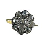 An 18ct yellow gold cluster ring, set with nine round old cut diamonds in a daisy design,