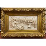 A decorative composite panel, moulded in relief with a classical scene depicting Cupid asleep,