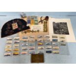 A mixed lot of military collectables including six cap and shoulder badges, trench-art kukri knife