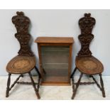 A pair of 19th century foliate-carved oak spinning stools, with turned supports and stretchers,