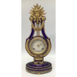 A reproduction Victoria & Albert Museum Marie-Antoinette porcelain mantel clock, lyre-shaped case