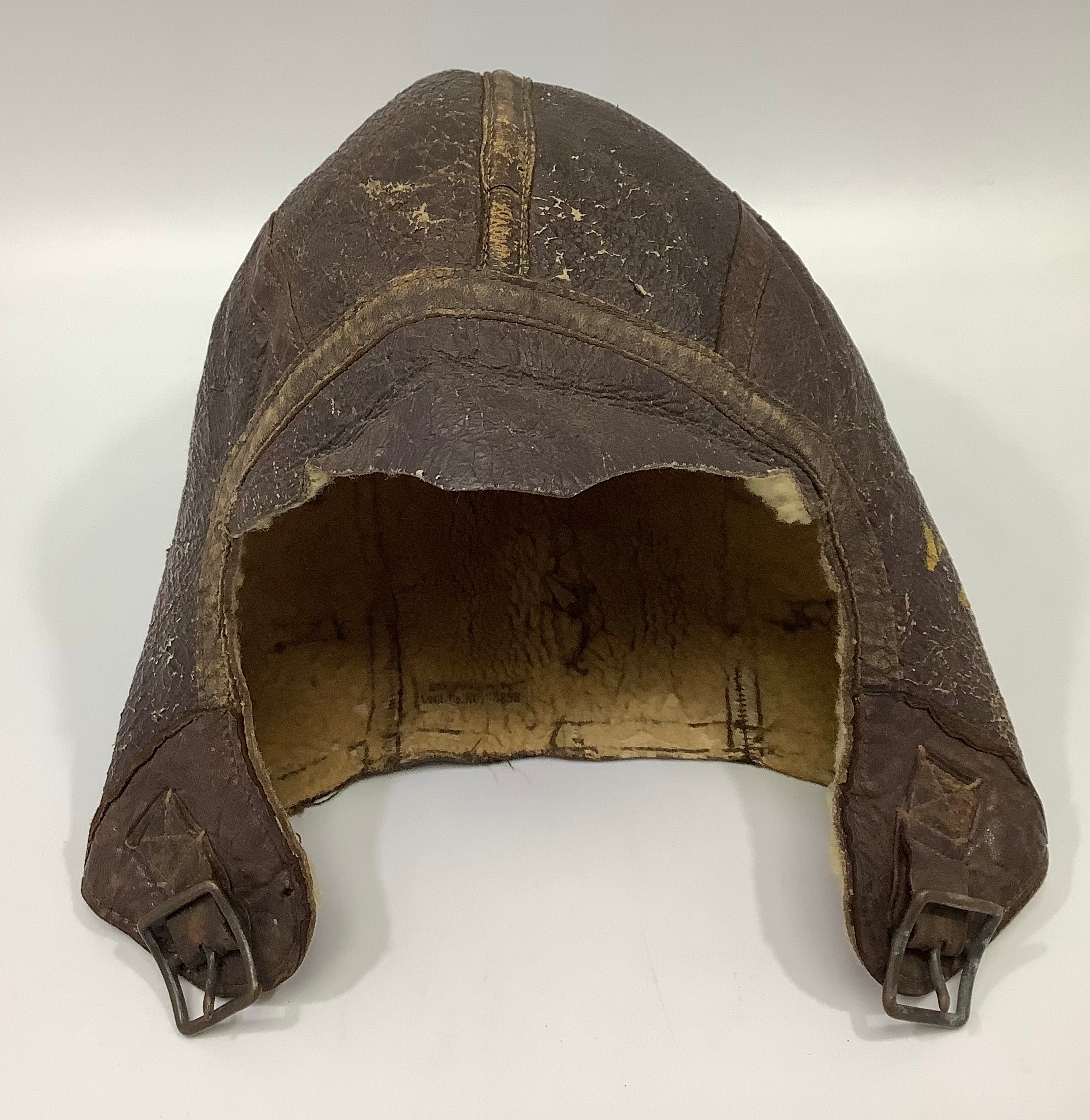 A WWII US Navy pilot's brown leather flying helmet/cap, with sheeps wool lining, (a/f)