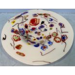 A large white opaque glass charger, decorated with multicoloured flowers, 47cm diameter