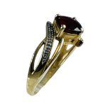 A 9ct yellow gold dress ring, claw set with a square faceted garnet to the centre, ring weighs 3.2